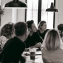 A team talking around a table, in black and white